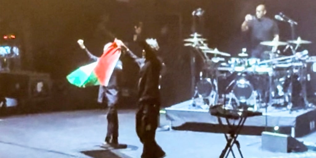 The British band Massive Attack says its members were detained by Singapore police and “isolated and separately questioned” after two performers raised a Palest
