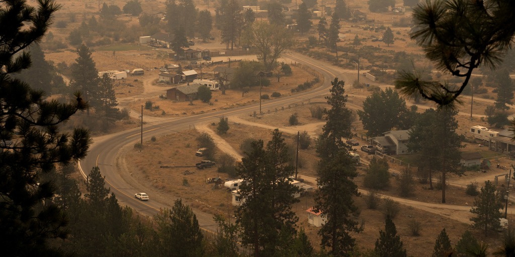 British Columbia declared a state of emergency Saturday after a fast-moving wildfire destroyed homes and forced more than 20,000 people to flee communities alon