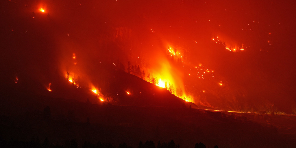 A deadly wildfire in western Canada that has forced some 20,000 people to flee, grew overnight even without strong winds, challenging efforts to contain it and 