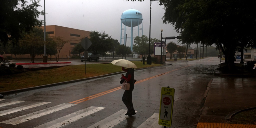 The former Tropical Storm Edouard weakens into a depression while unleashing heavy rains and strong winds on parts of Texas, knocking out power to thousands, to