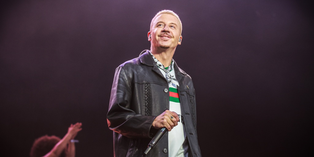 Macklemore has been dropped from Ed Sheeran’s tour after he says New England Patriots owner Robert Kraft organized a boycott among stadium owners over the rapper’s remarks in support of Palestinians.