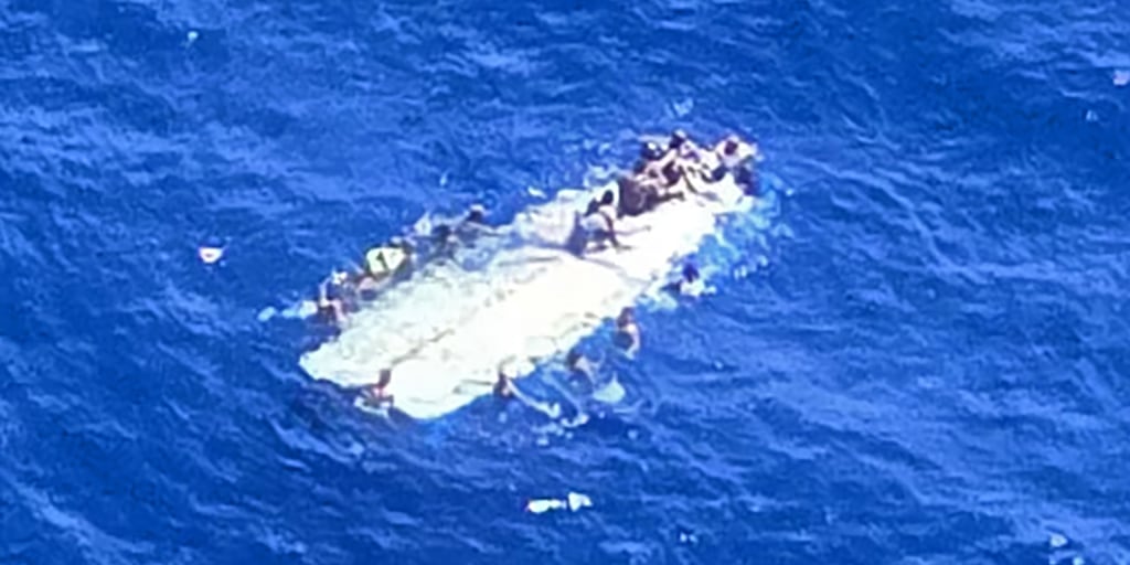 The U.S. Coast Guard says that it rescued at least 40 people in open waters after their boat capsized several miles from a tiny, uninhabited island west of Puerto Rico.