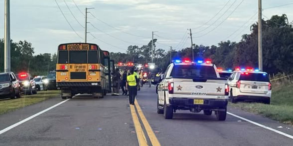 A school bus carrying 39 people was struck by a car in Central Florida, killing two people, including a 10th-grade student, deputies say.