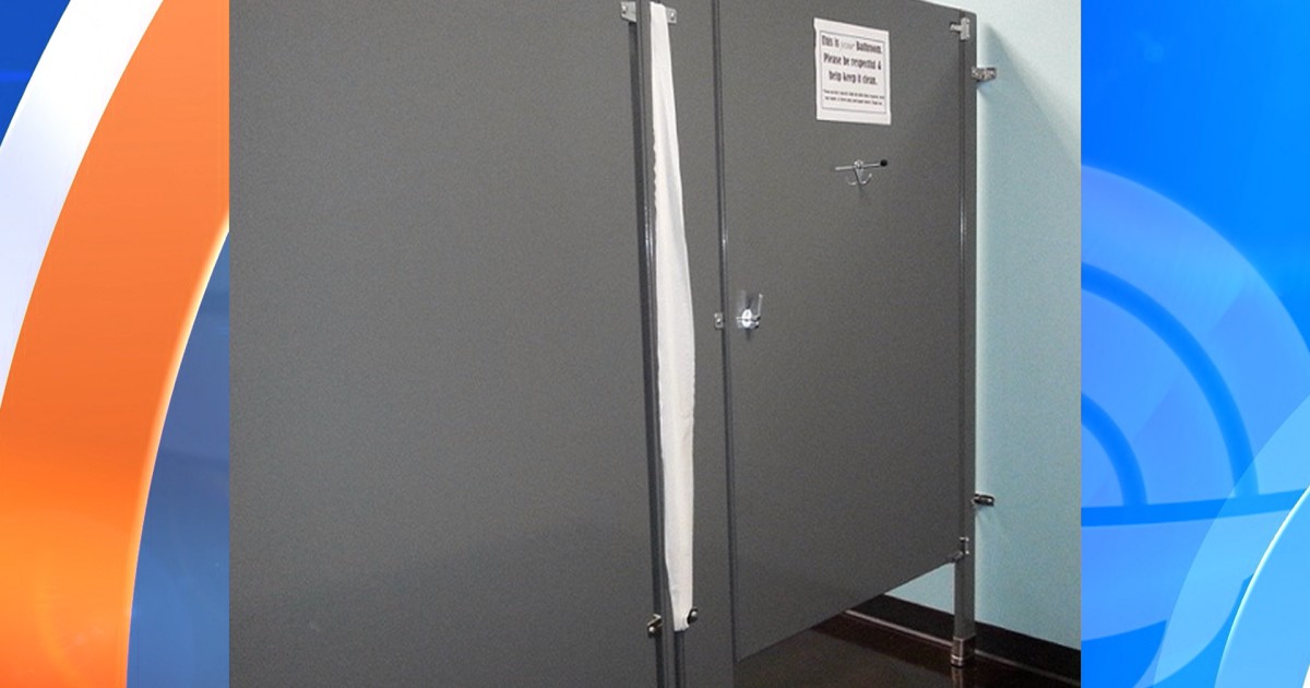 Why do public toilets in the US have wide gaps around the doors?