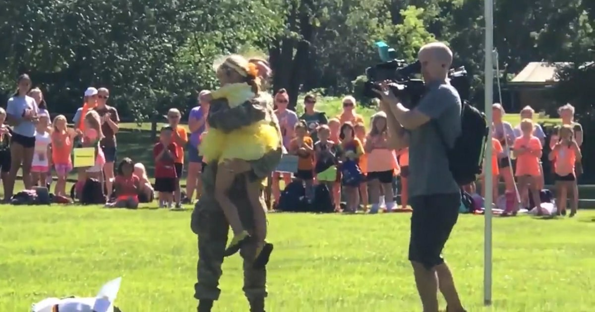 a military mother surprise daughter at camp dressed as giant flower