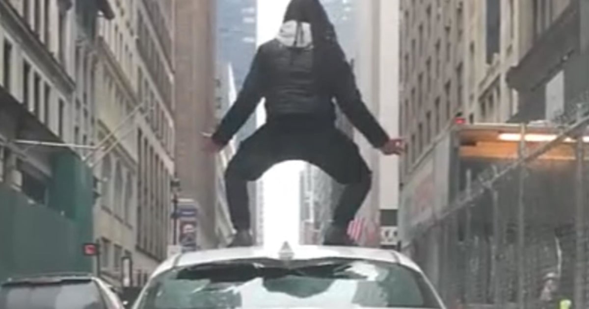 New York City bicyclist attacks Uber driver, jumps on top of car
