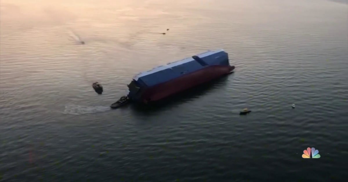 Four missing after cargo ship overturns off coast