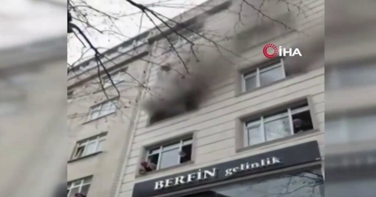 Children dropped from window of burning building in dramatic rescue