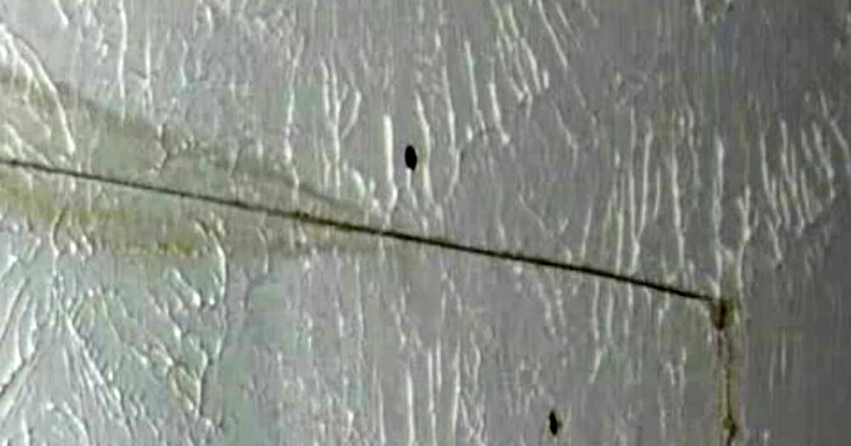 Woman: Upstairs man pees in holes he drilled