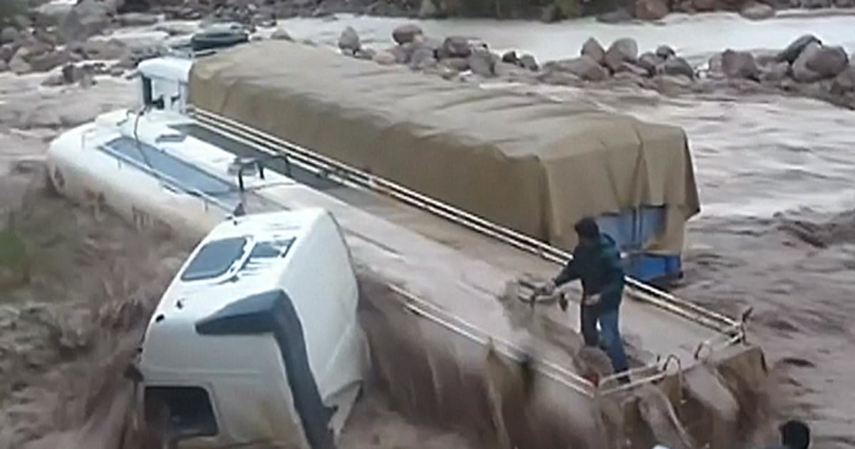 Watch Dramatic Rescue Unfold of Truck Driver Stranded in Floods