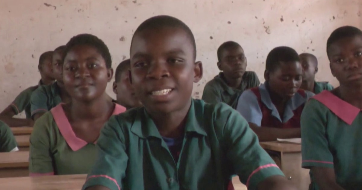 K.I.N.D. student sits at a desk for the first time