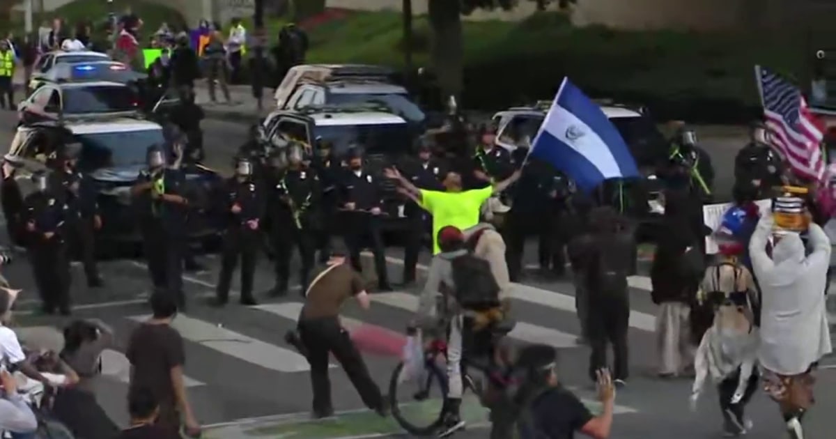 Reporter falls back with dispersed L.A. protesters amid flash-bangs, tear gas