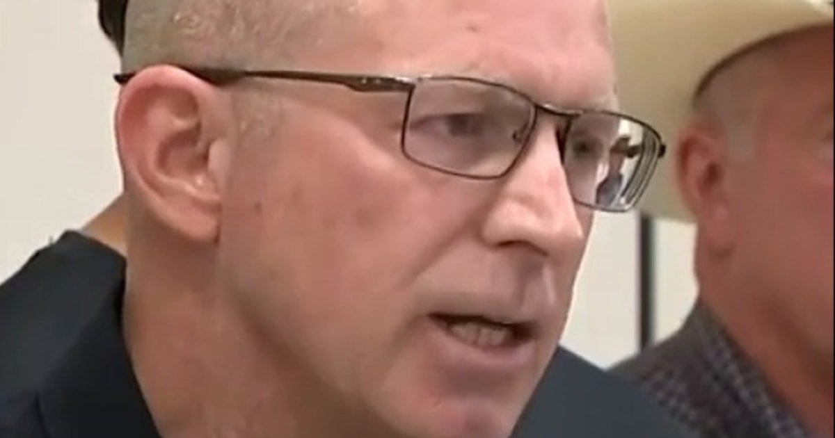 Police officer asks sightseers - 1752080190900 F Vert Police Avoid Flood Zones 250709 720x1280 X2u6hw 