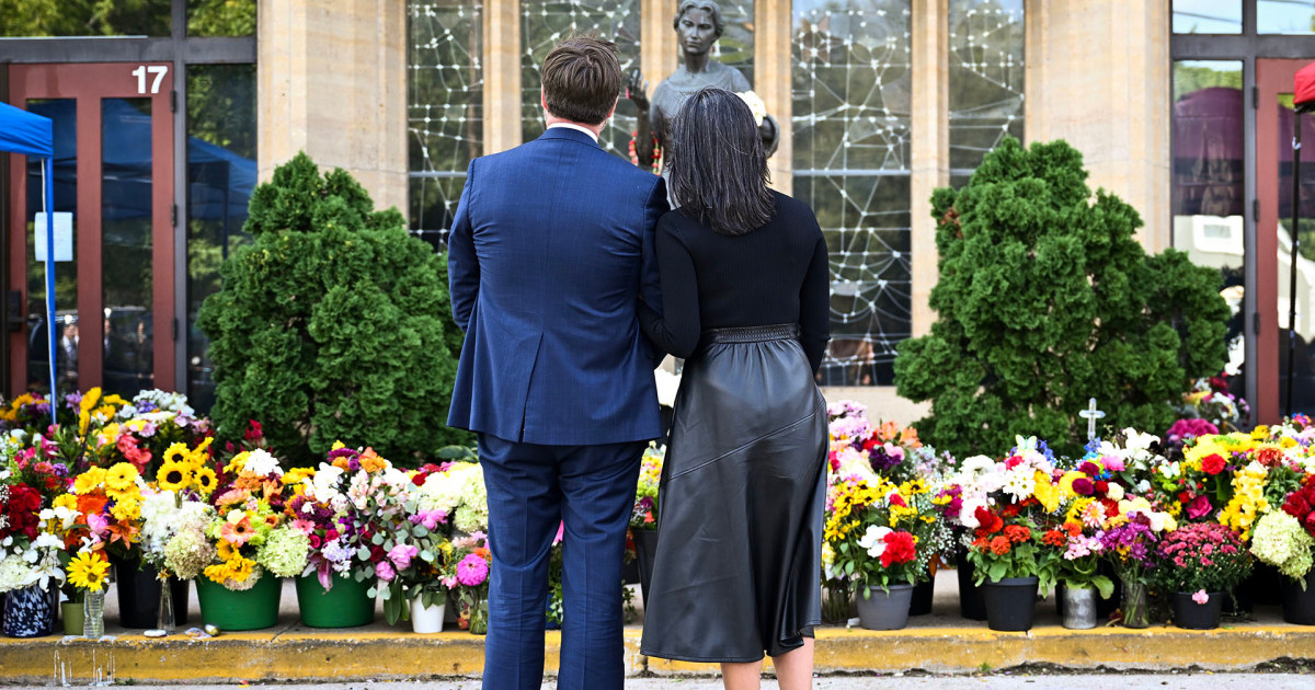 Vances lay flowers at Annunciation Catholic Church memorial