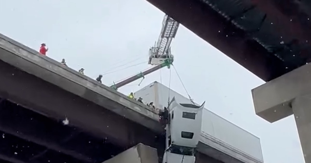 Driver rescued from dangling truck on West Virginia overpass