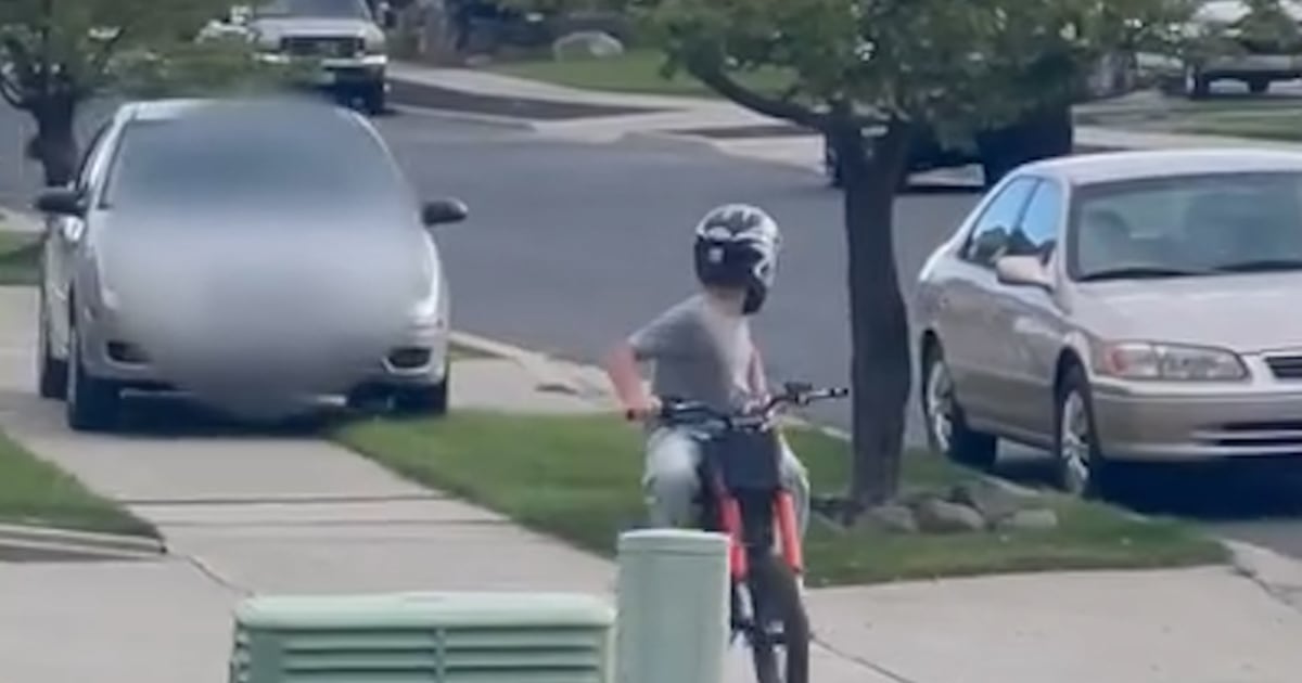 Car captured driving onto sidewalk after child on bike