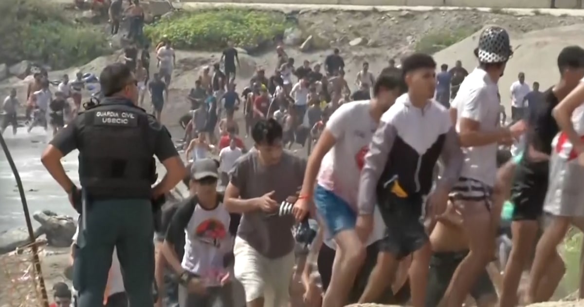 Thousands of migrants force their way into Spain’s African territory Thousands of migrants force their way into Spain’s African territory