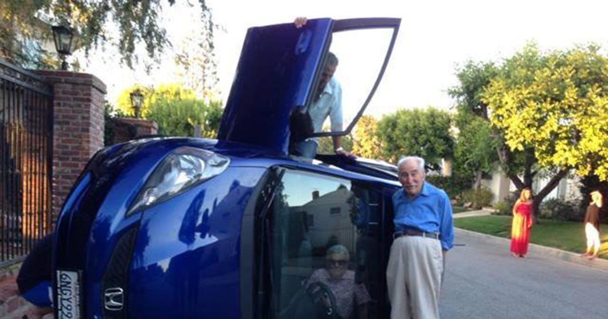 Elderly Couple Poses for Photo After Car Flips