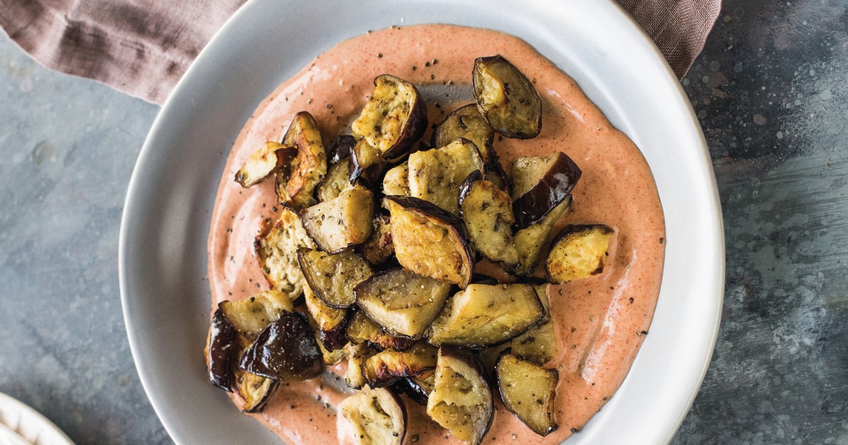 Switch up your side dish routine with this caramelized eggplant with harissa yogurt recipe
