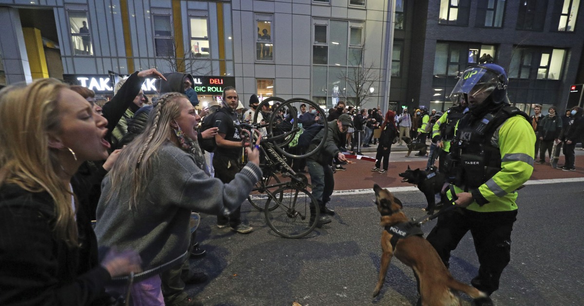 Police officers hurt, vehicles set on fire during protest in Bristol