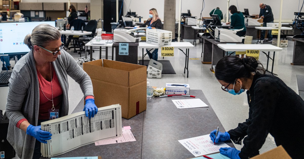 Election workers process completed ballots at the Maricopa County ...