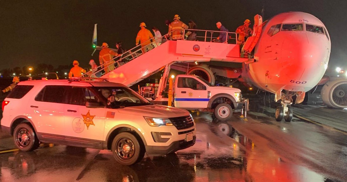 Sparks fly from Alaska Airlines plane after it lands in Southern