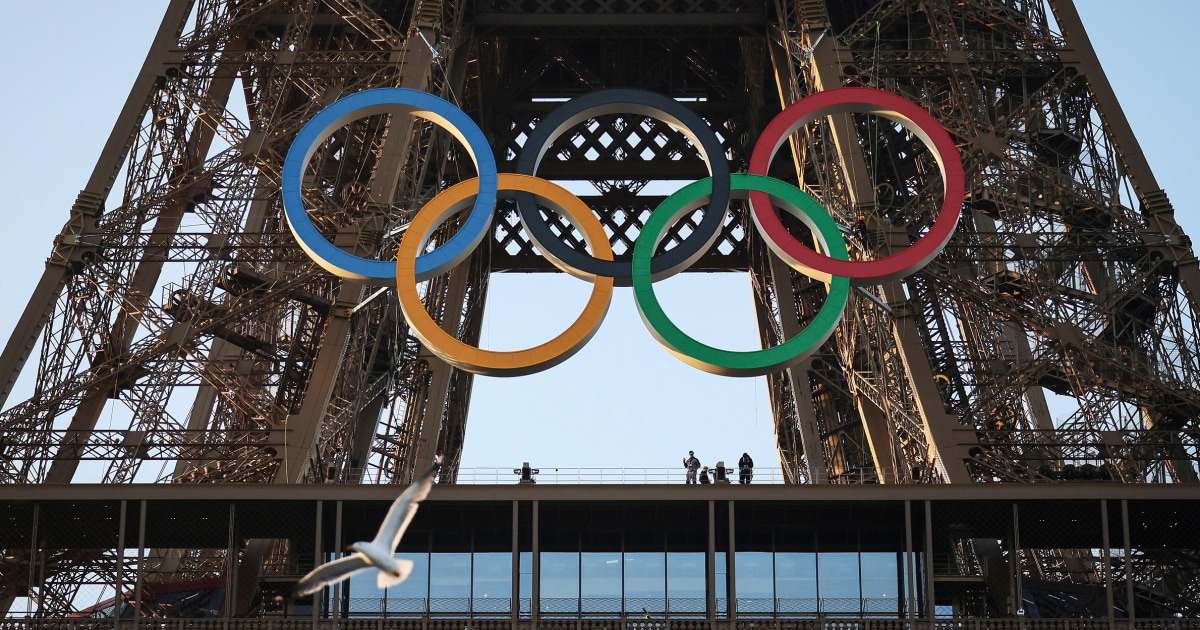 Paris Olympics rings mounted on the Eiffel Tower