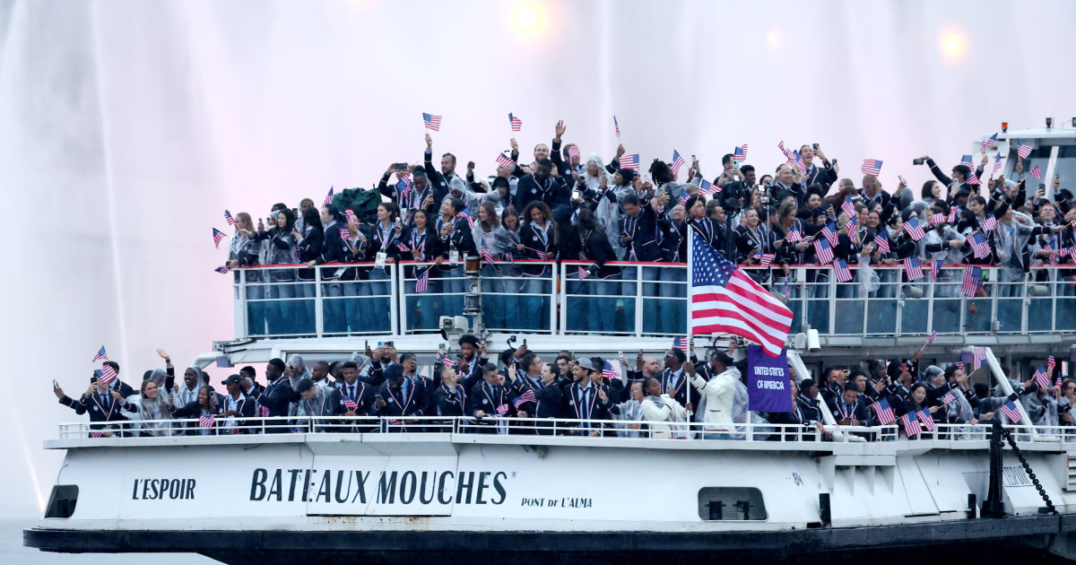 Photos: Procession of boats, flags and joyous athletes float down the Seine
