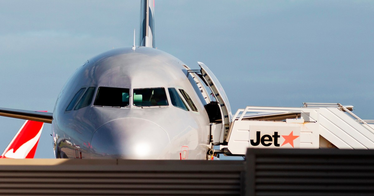 Man arrested at airport after opening plane door and walking onto wing