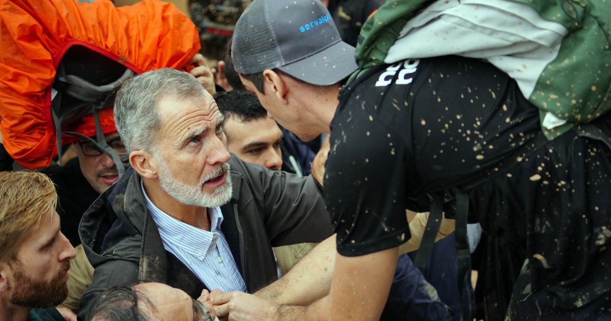 Angry crowds throw mud and shout insults at Spanish king as he tours flood damage