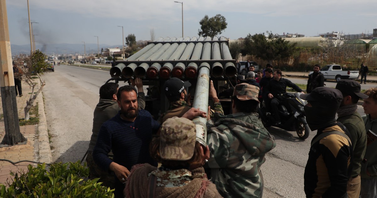 Bodies are piled in the street as violence escalates between Syrian forces and Assad loyalists