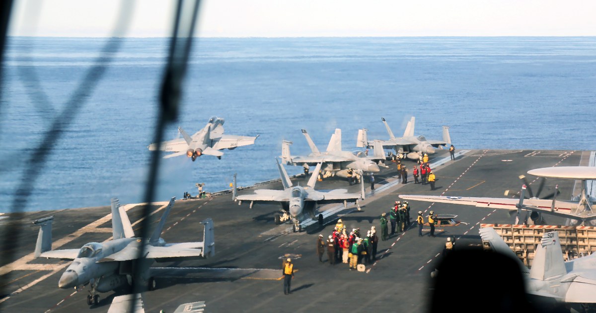 Onboard a U.S. aircraft carrier as tensions rise over Russian incursions into NATO airspace