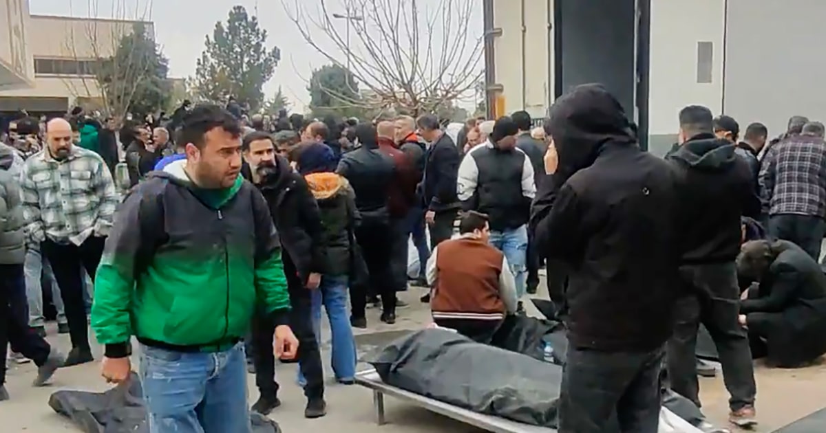 Grief, fury and despair as relatives search through body bags at one Iranian morgue