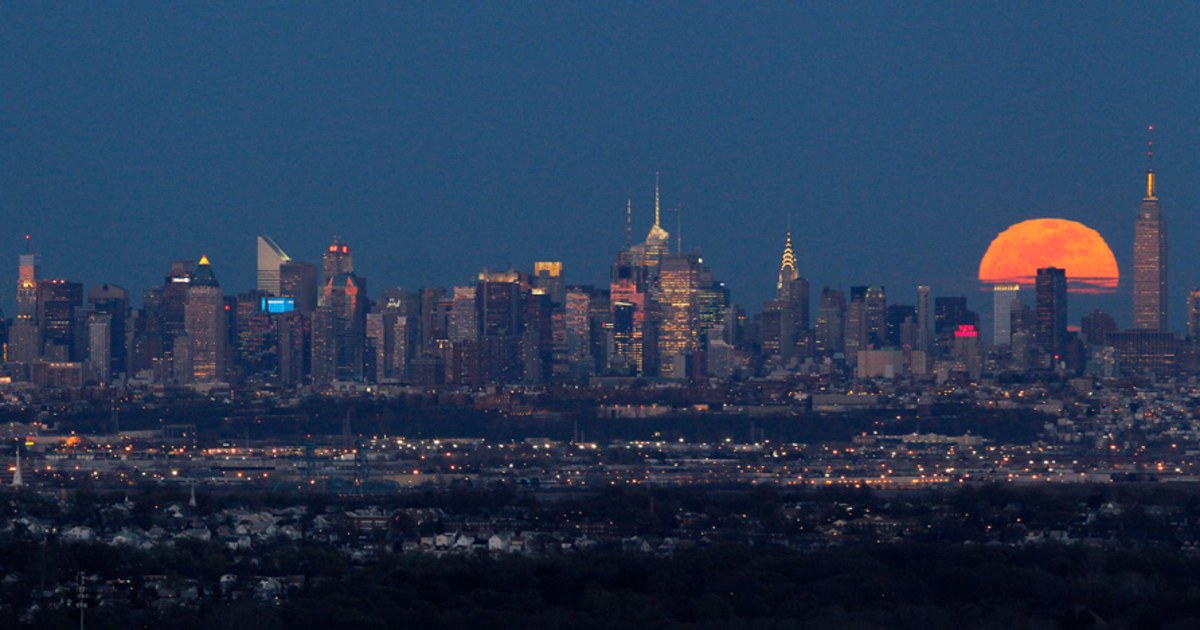 Full moon rises behind New York City