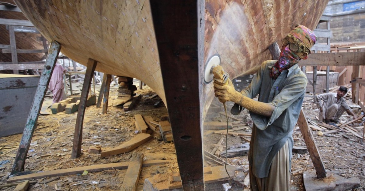 Making sawdust while refurbishing a boat in Pakistan