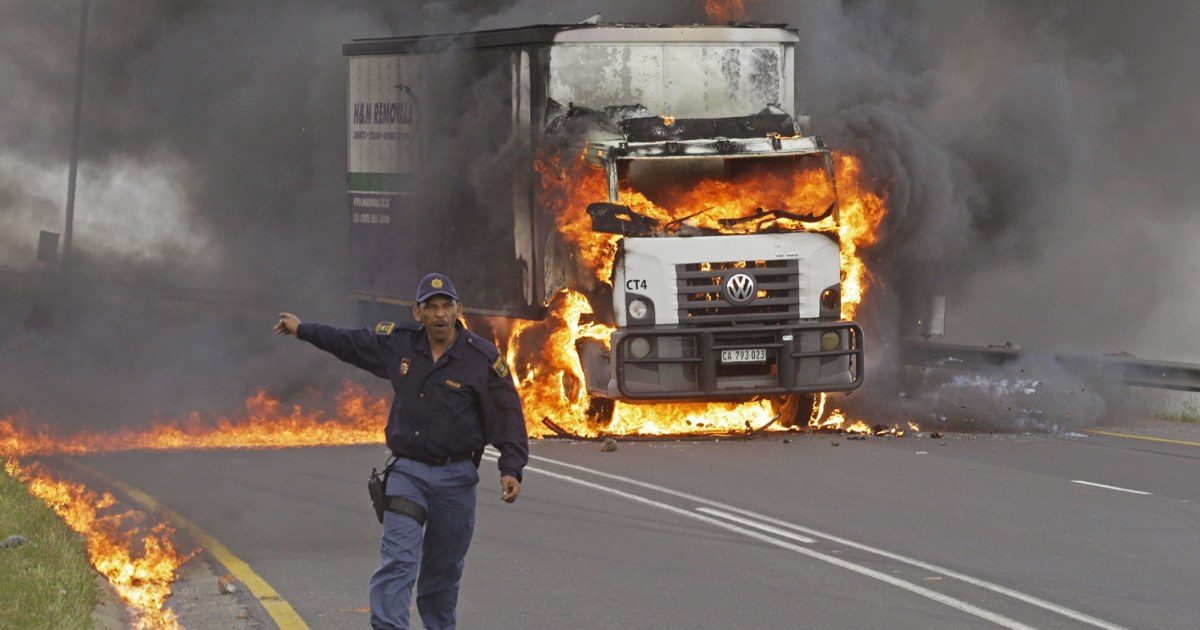Striking South African truck drivers torch vehicle