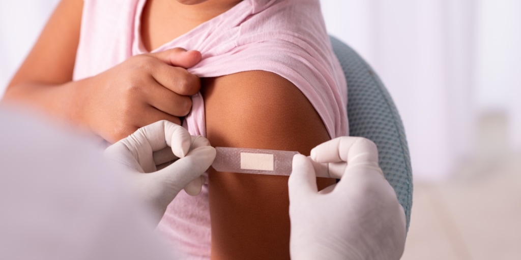 Doctor tries to calmly explain vaccines while the federal government speed-runs a Facebook comments section into national policy.