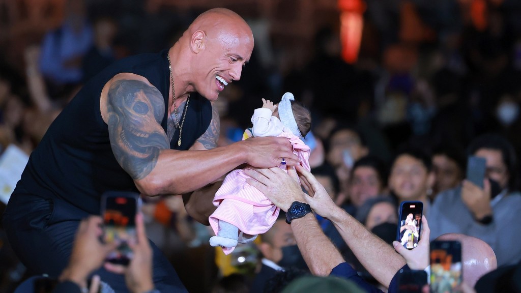 Watch dad crowd-surf his baby to The Rock at event in Mexico City