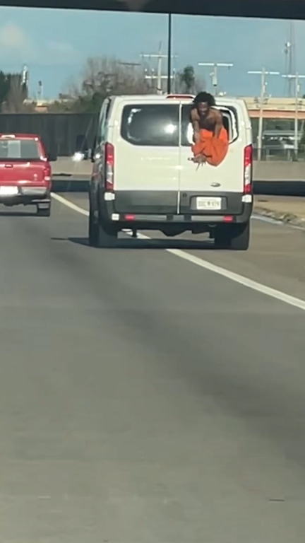 Video shows inmate hanging out of transport van