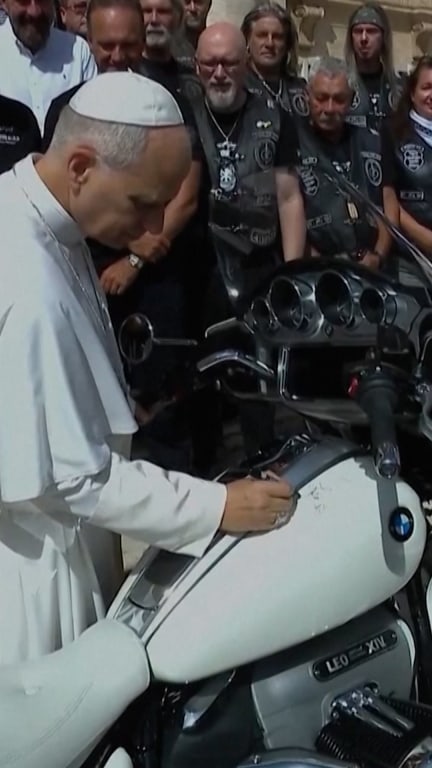 Pope Leo poses with motorbike for charity auction