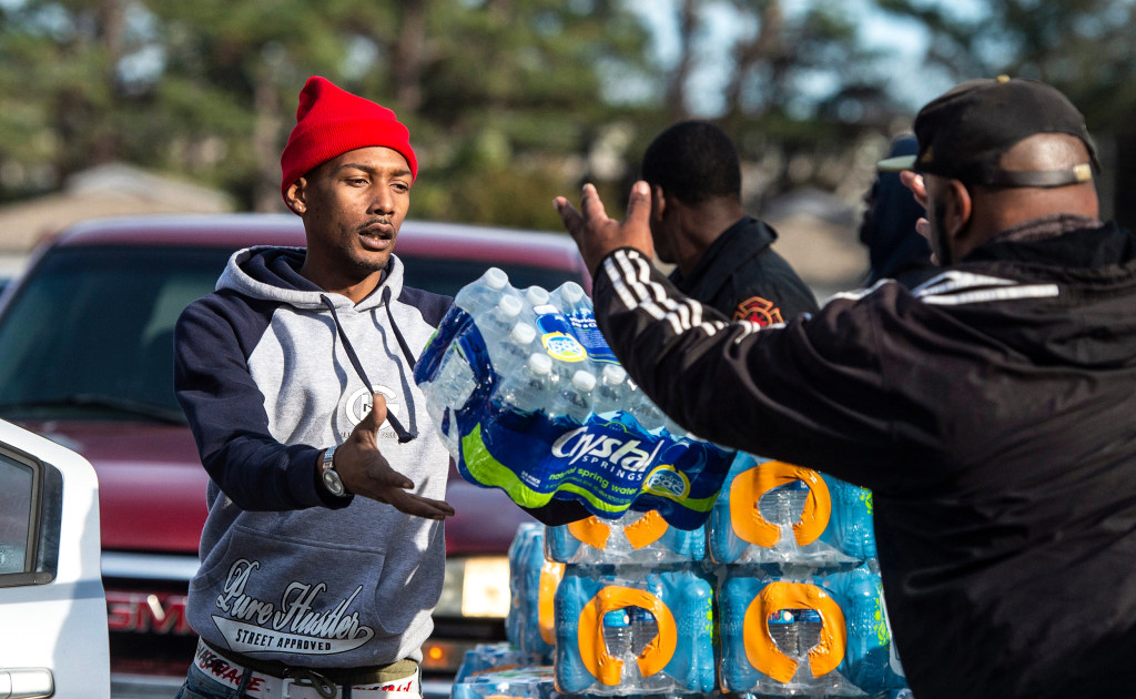 Groups collect, distribute water bottles for residents in parts of