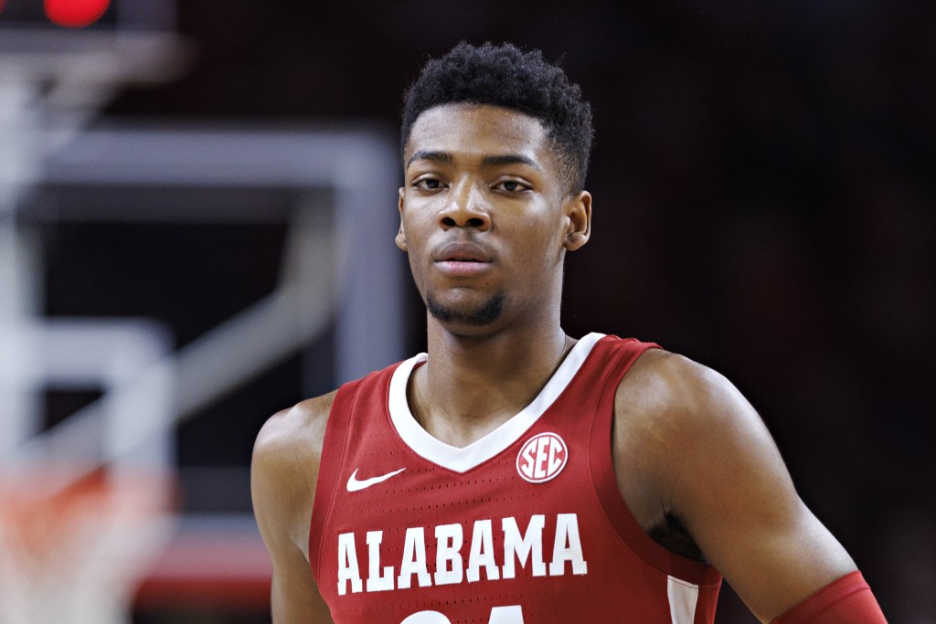 Alabama basketball's Brandon Miller is protected by ARMED SECURITY