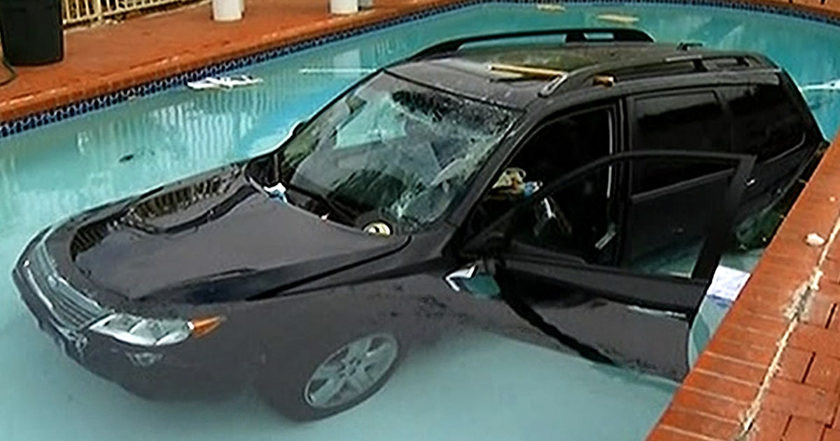 Woman crashes car through garage, 2 fences, lands in pool