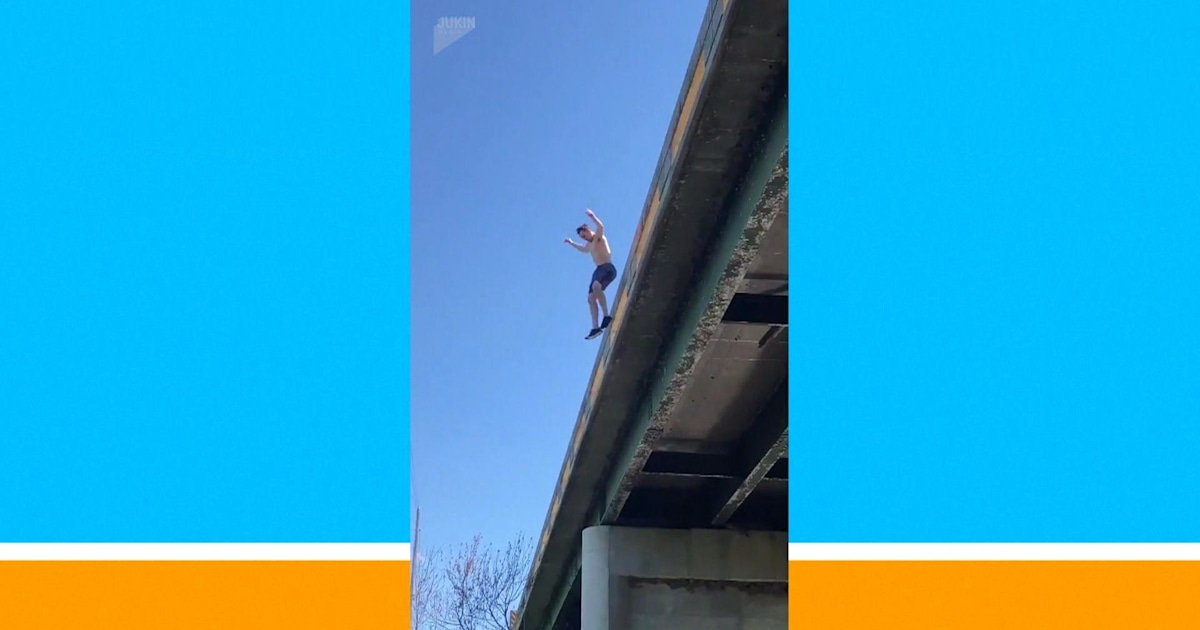 Watch this daredevil jump off a bridge – and come up with a fish
