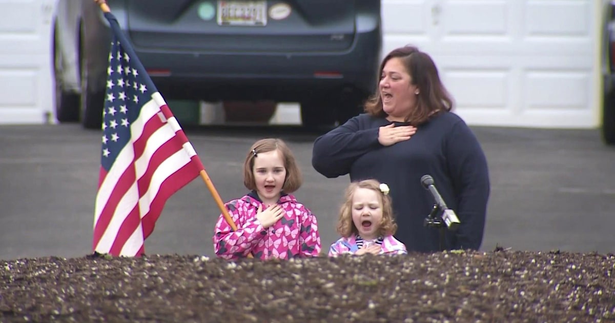 Kids home from school recite Pledge of Allegiance in their driveways