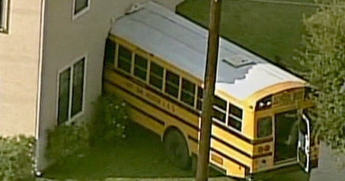 School bus filled with kids crashes into home