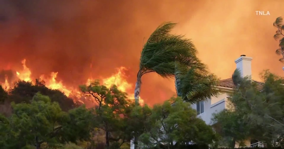 Firefighters race to contain LA wildfires before winds pick up again