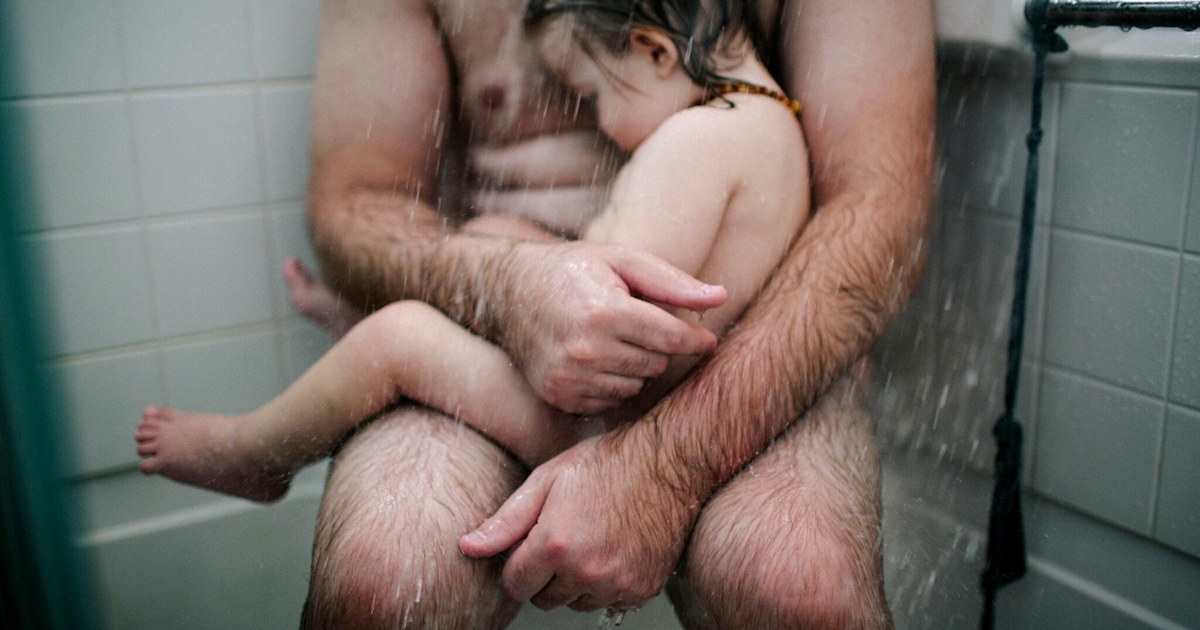 Photo of a dad comforting his son in the shower goes viral picture