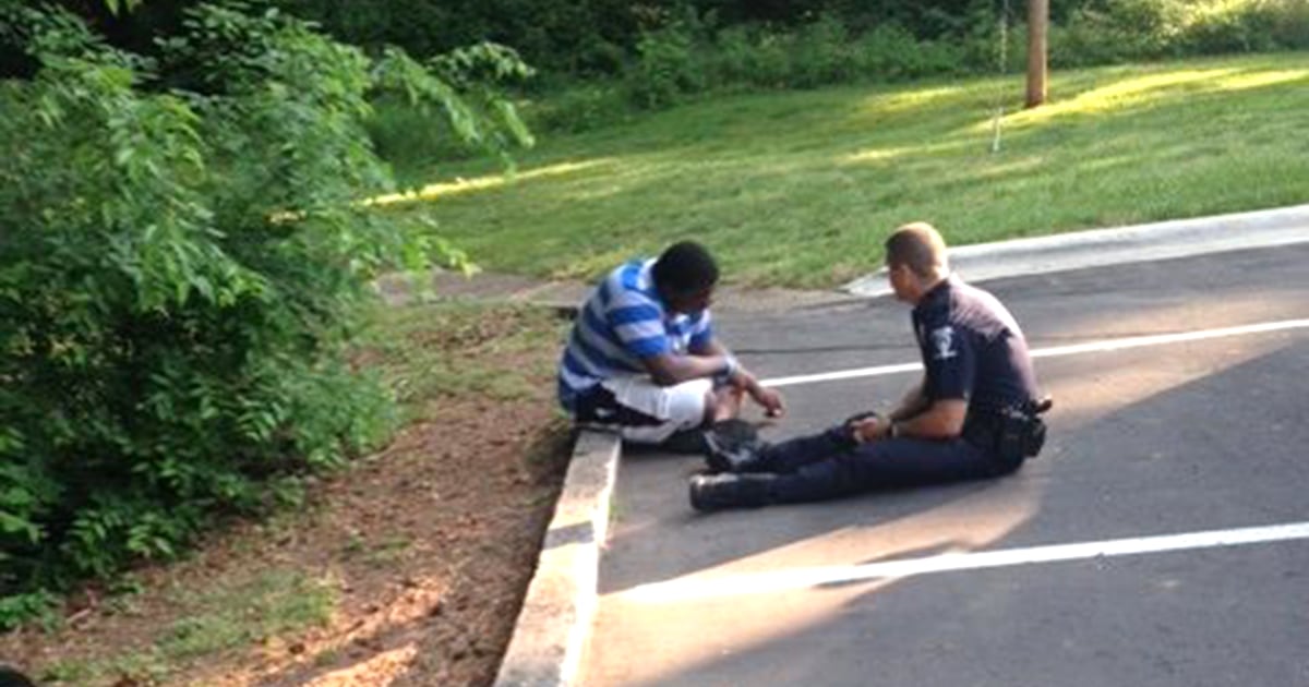 Police officer helping teen with autism viral photo