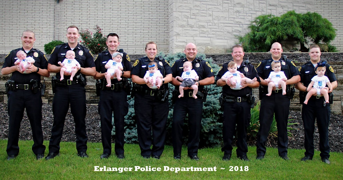8 police officers from same department pose with their newborns